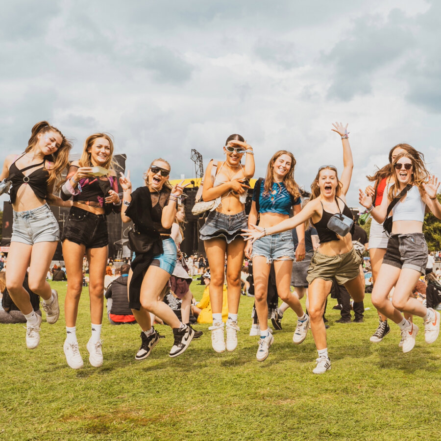 A row of people jumping in a festival field